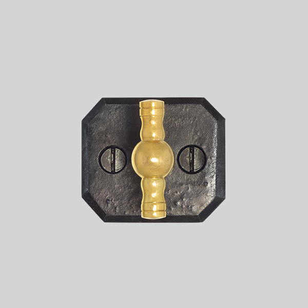 Shown with a dark wax iron and polished brass finish.